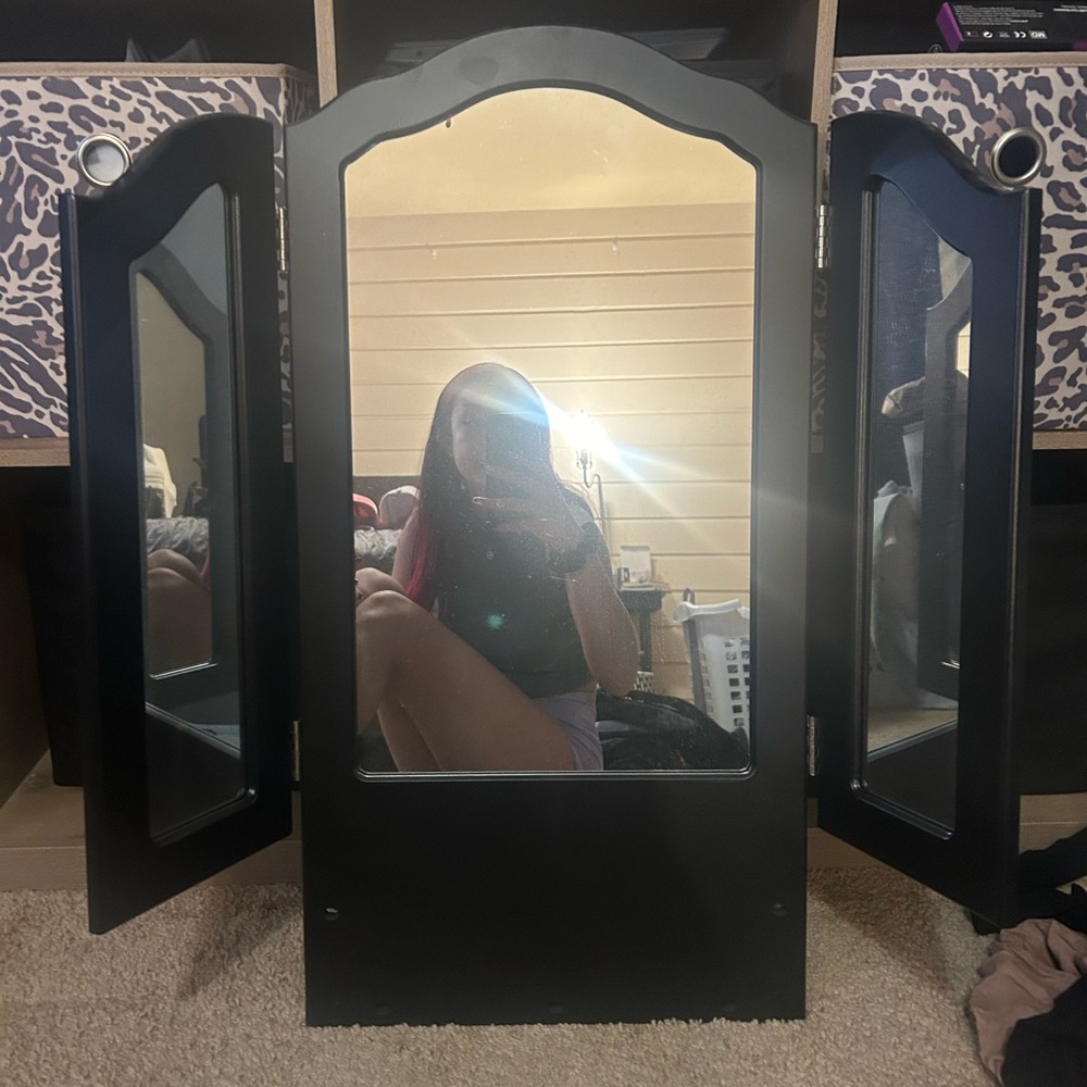 Black vanity piece mirror with jewelry hooks